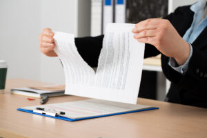 businesswoman tearing up a document